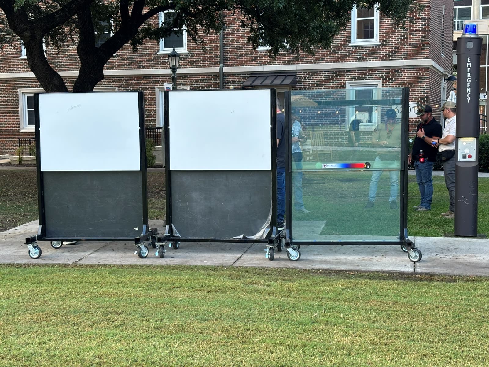 A.S.E.S.S. Boards staged alongside a ballistic glass panel at a live agency demonstration