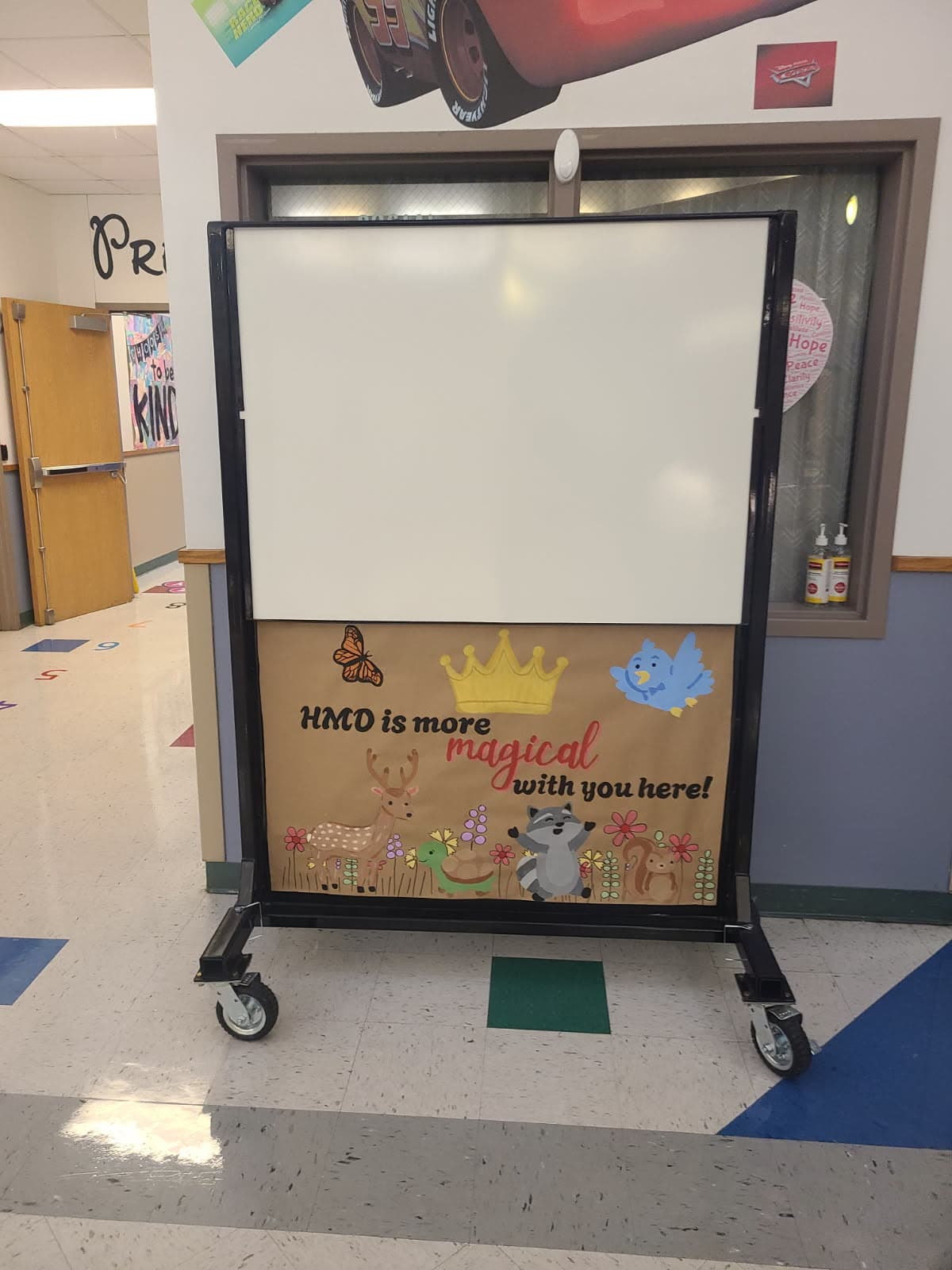 A.S.E.S.S. Board staged in an elementary school corridor, indistinguishable from standard classroom furniture